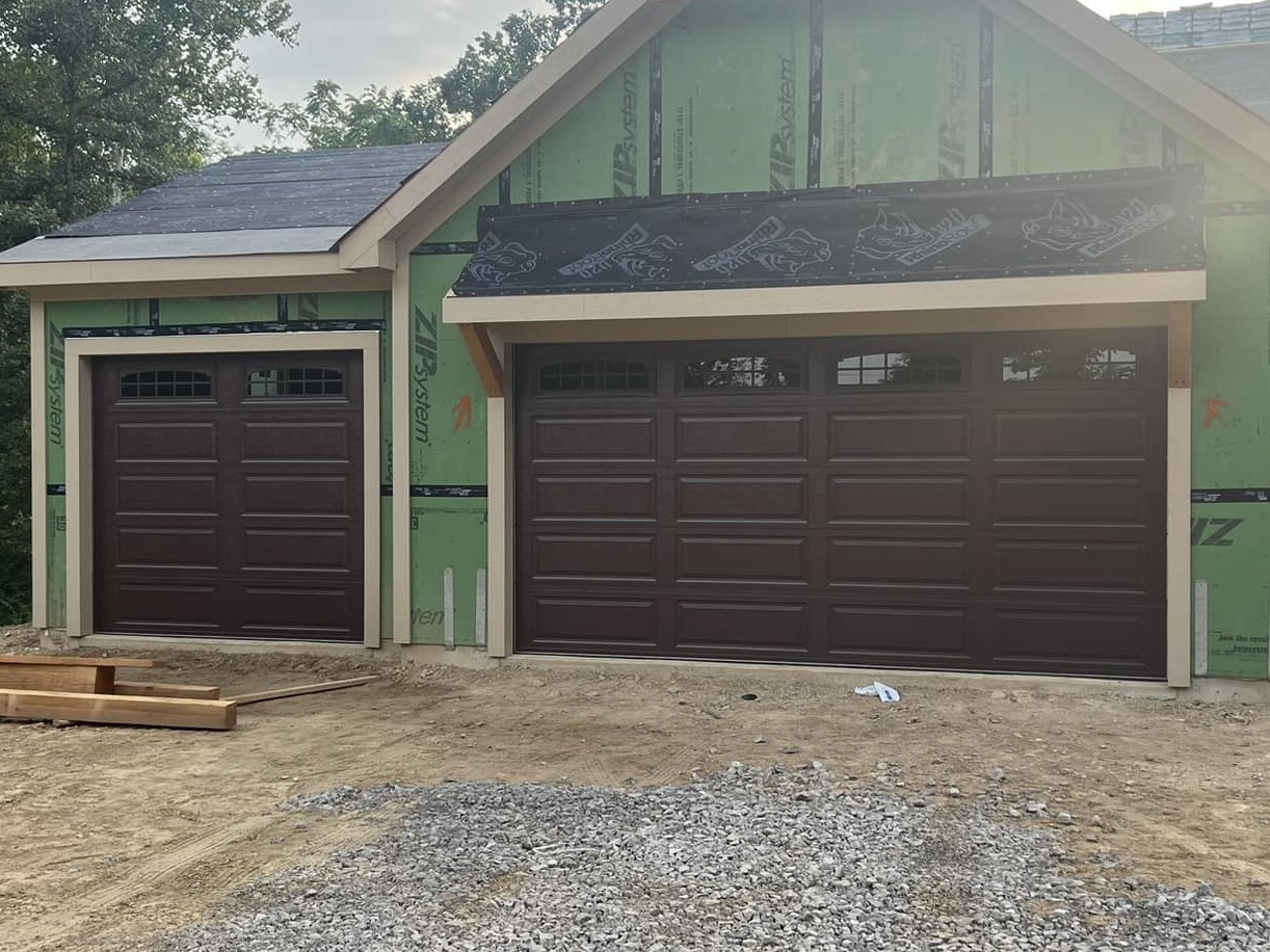 New construction brown garage doors installation