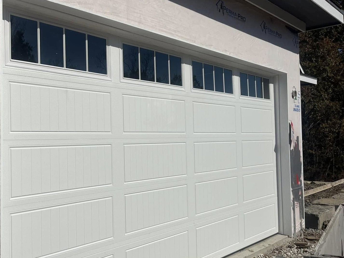 White garage door with windows installation