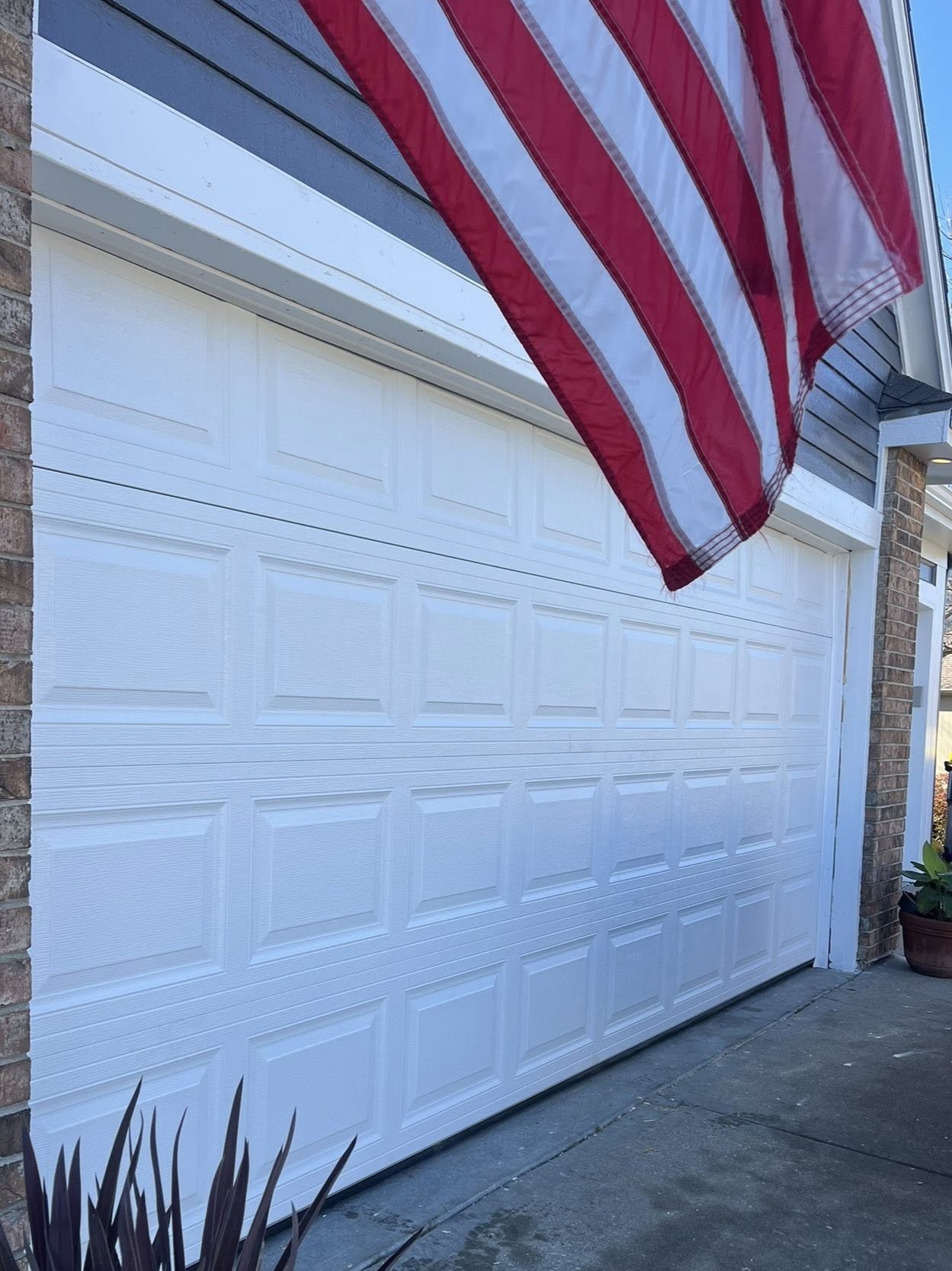 White residential garage door installation