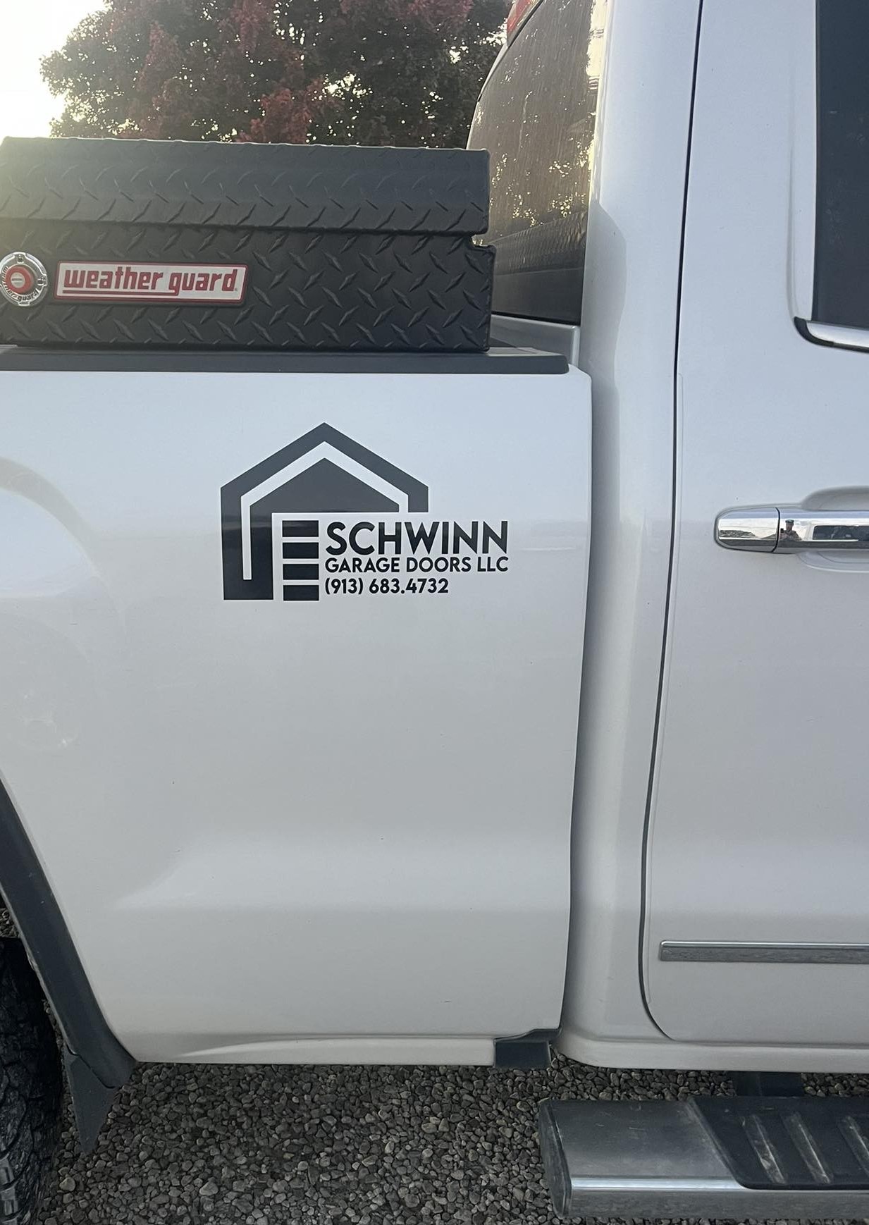 Schwinn Garage Doors service truck logo and phone number